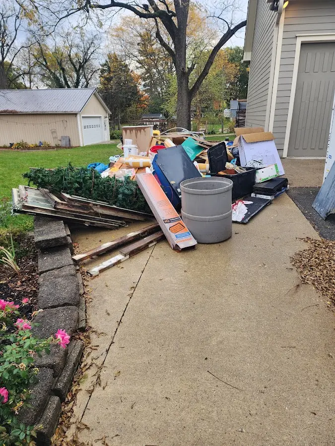 Dumpster being loaded with debris for Roofing Dumpster Rental in Hoboken
